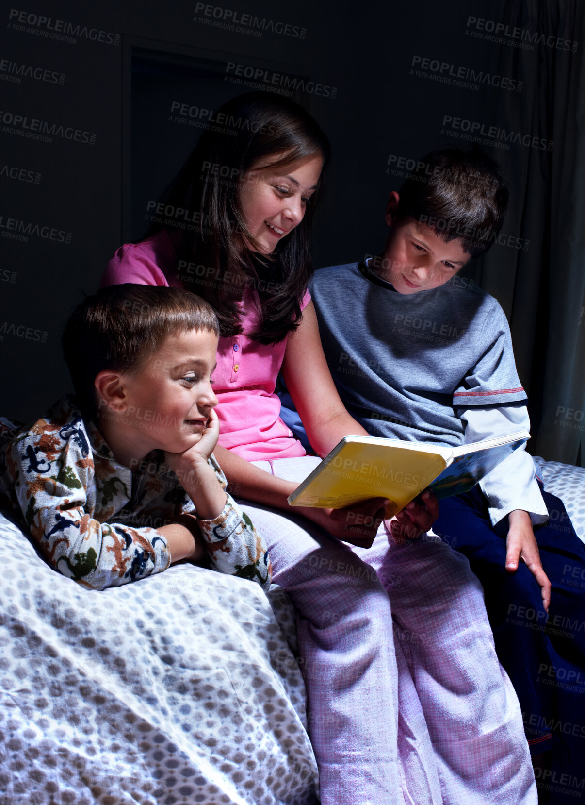 Buy stock photo Children, book and reading bedtime story, fantasy or siblings learning in dark home at night. Happy kids, family and storytelling in bedroom for education, fairytale or sister bonding with brothers