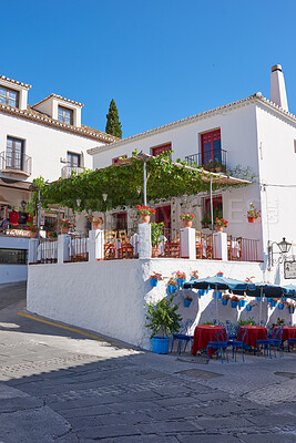 Buy stock photo Outdoor, houses and restaurant in street with traditional architecture in Spain. Outside, neighborhood and road in village in cultural or vintage design as holiday or vacation destination for tourism