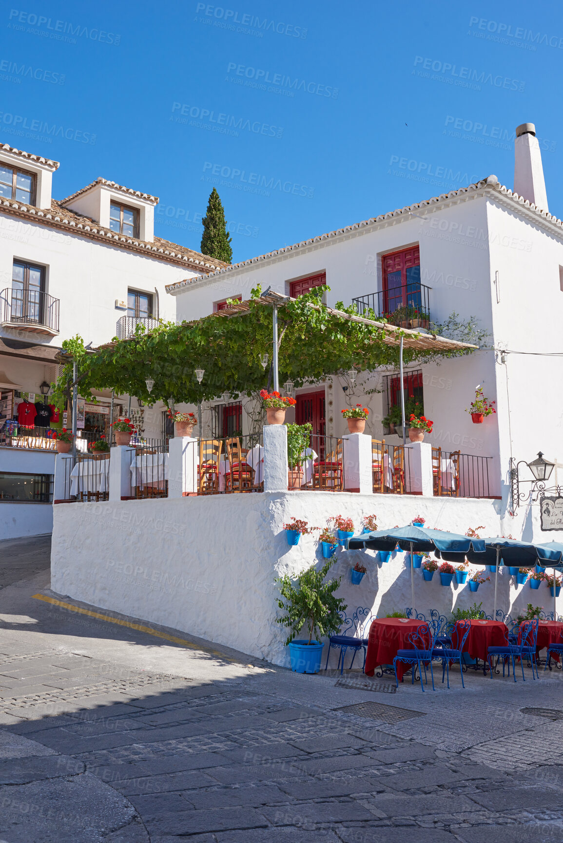 Buy stock photo Outdoor, houses and restaurant in street with traditional architecture in Spain. Outside, neighborhood and road in village in cultural or vintage design as holiday or vacation destination for tourism