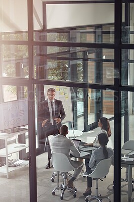 Buy stock photo Shot of a businessman giving a presentation in the boardroom