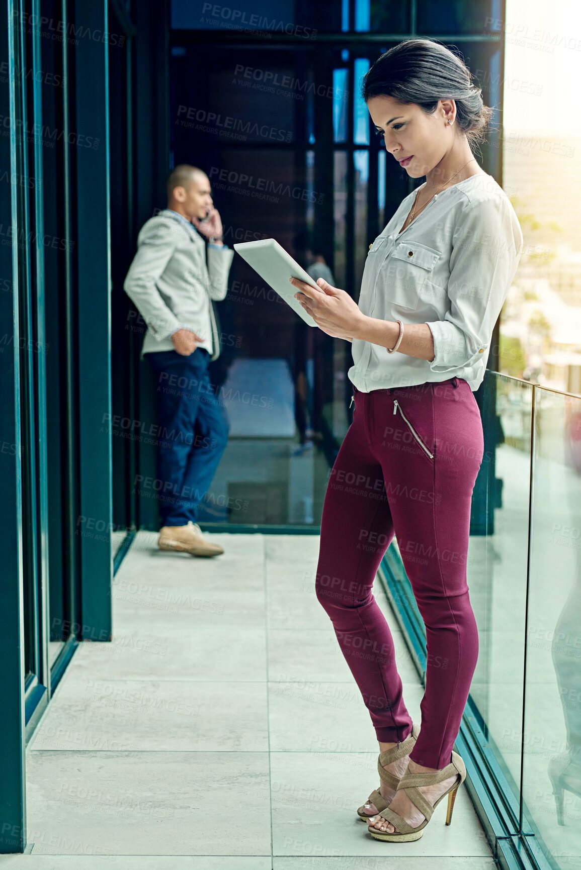 Buy stock photo Shot of a young businesswoman using a digital tablet at work