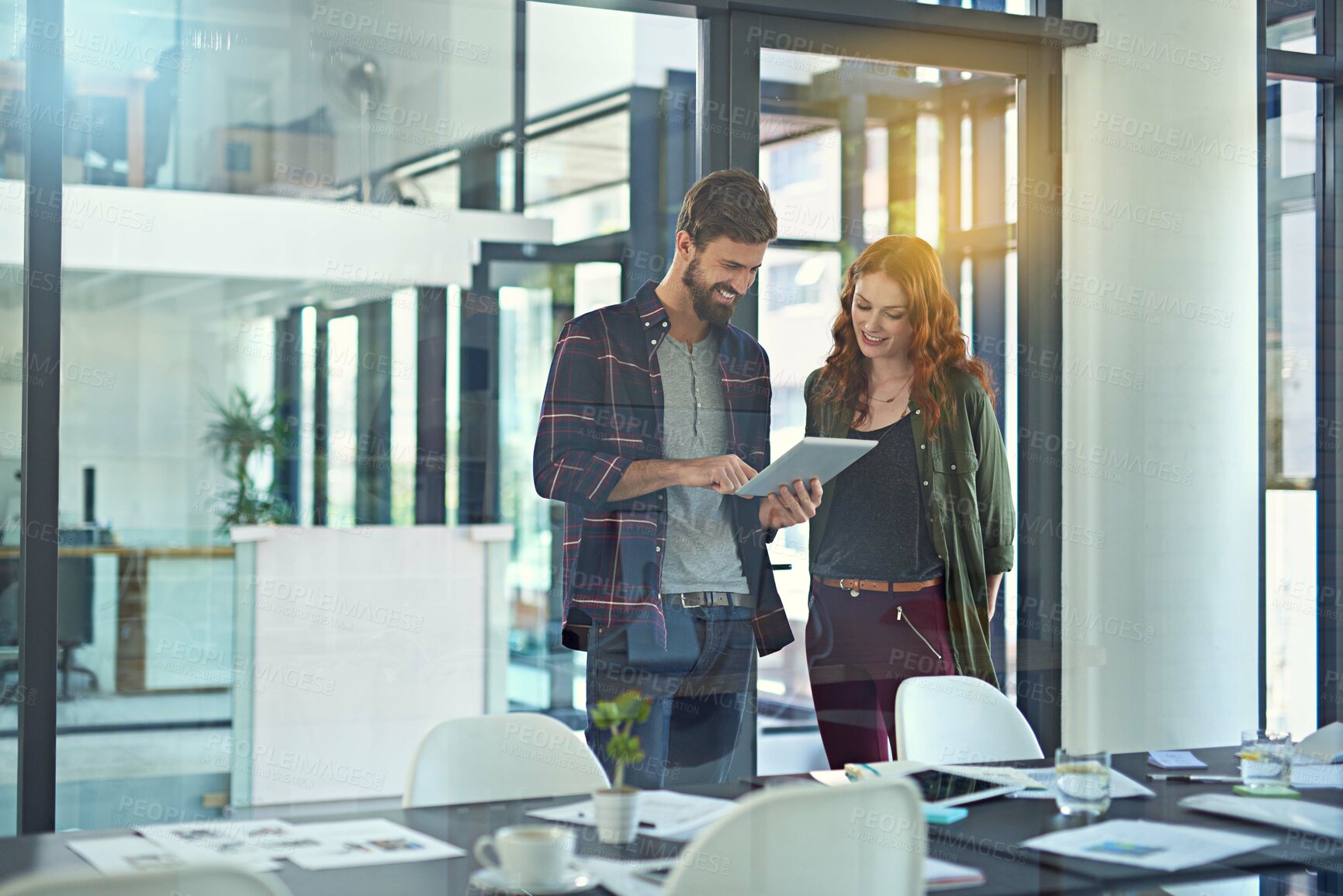 Buy stock photo Cropped shot of colleagues working together on a digital tablet in a modern office