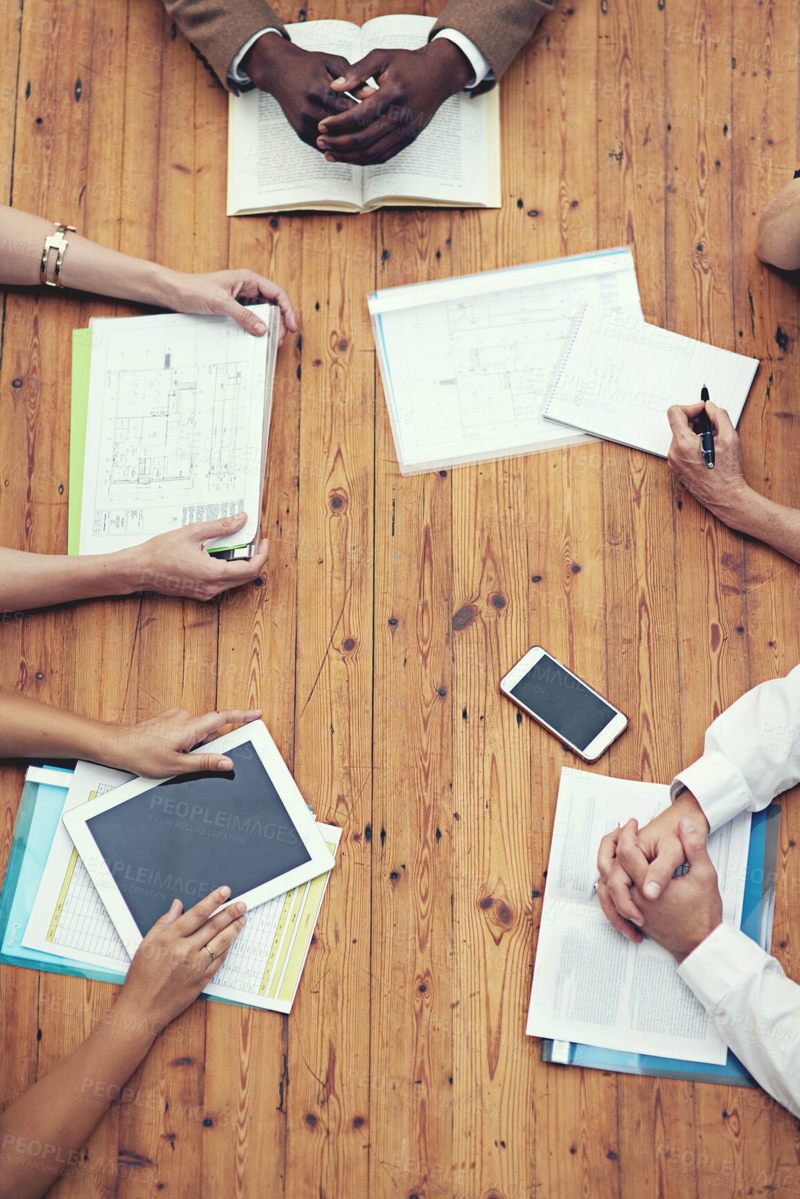 Buy stock photo High angle shot of a group of businesspeople having a meeting in an office