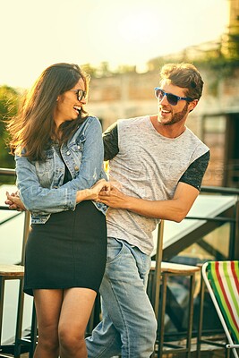 Buy stock photo Shot of an affectionate young couple enjoying a day outdoors