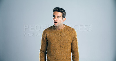 Buy stock photo Scared, man and anxiety with fear in studio for horror, terror and stress for danger on mockup space. Worried person, nervous and suspense with surprise and overwhelmed by bad news on gray background