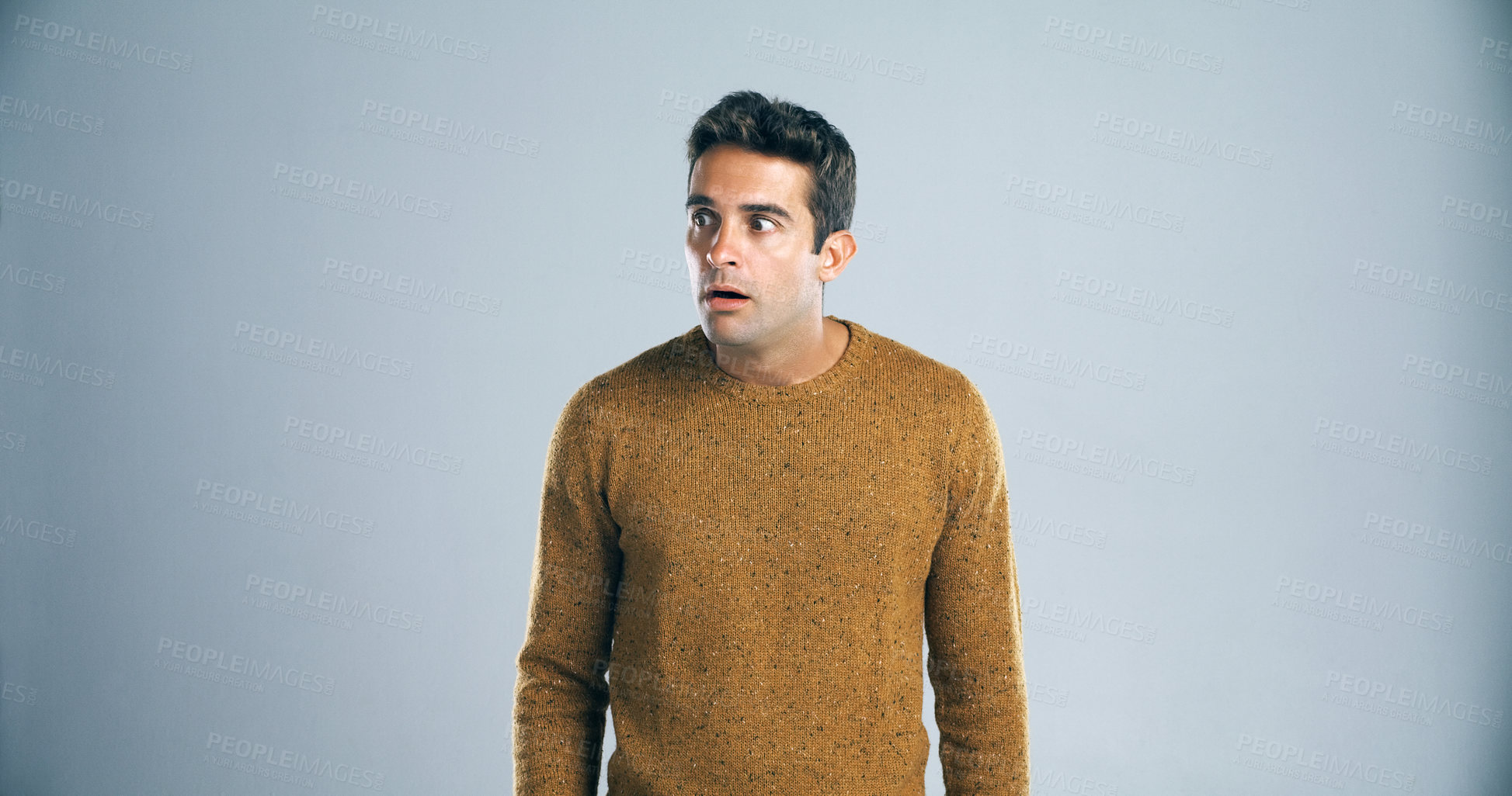 Buy stock photo Scared, man and anxiety with fear in studio for horror, terror and stress for danger on mockup space. Worried person, nervous and suspense with surprise and overwhelmed by bad news on gray background