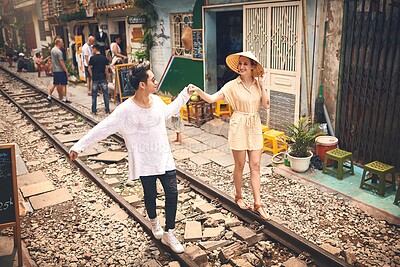 Buy stock photo Couple, love and walking by railway for holiday, relationship and travel adventure with portrait. People, trip and happy in Vietnam for vacation, romance and holding hands on date with train track