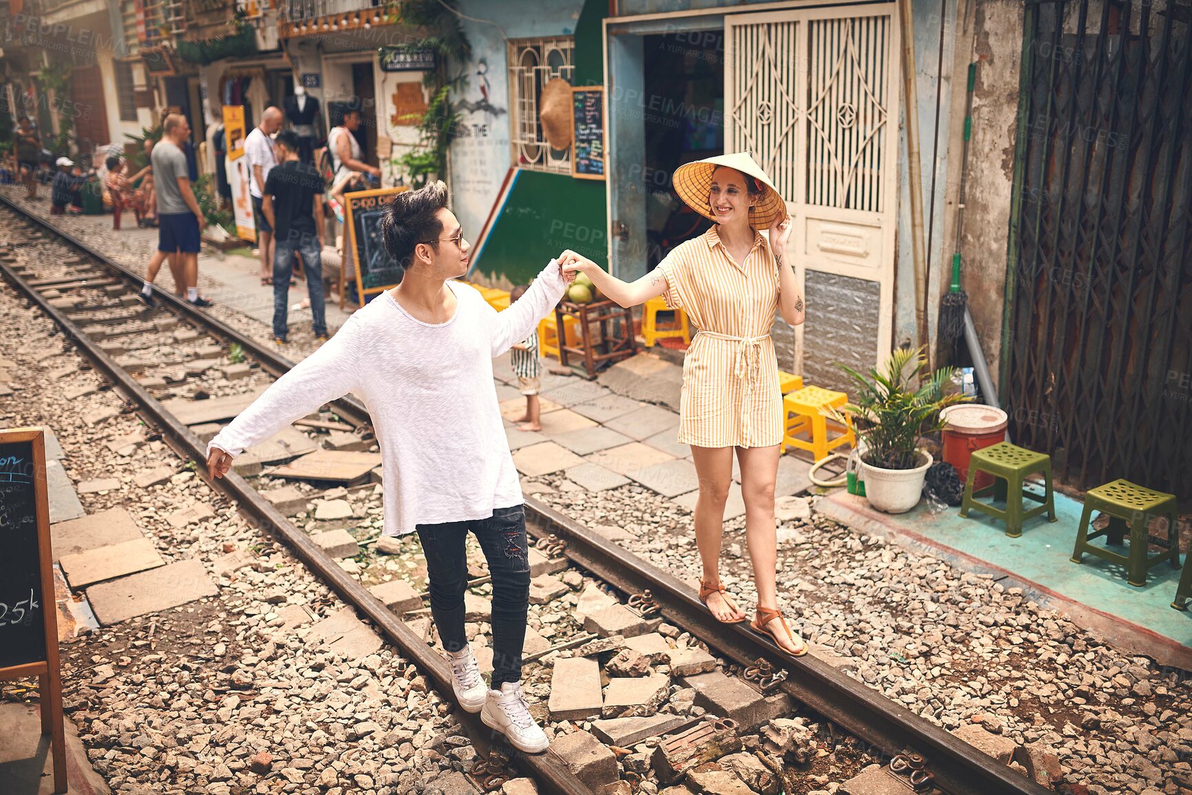 Buy stock photo Couple, love and walking by railway for holiday, relationship and travel adventure with portrait. People, trip and happy in Vietnam for vacation, romance and holding hands on date with train track