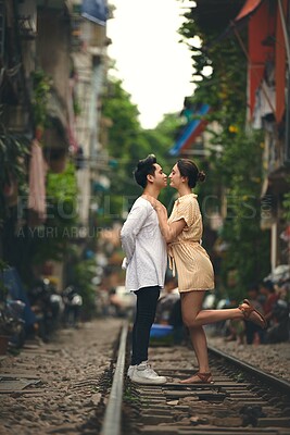 Buy stock photo Travel, love and couple on train tracks in Vietnam for holiday, vacation and tourist destination. Happy, affection love and man and woman on railway for adventure, journey and bonding in urban city