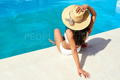 Buy stock photo Back view, relax and woman tanning by swimming pool for holiday, travel and outdoor vacation. Bikini, summer hat and tourist sunbathing by water at hotel, lodge and resort to chill on weekend break