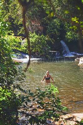 Buy stock photo Waterfall, happy and woman swimming on mountain for adventure at travel destination, nature and outdoors. Trees, journey and person relax in water, dam and stream for holiday, vacation and tourism