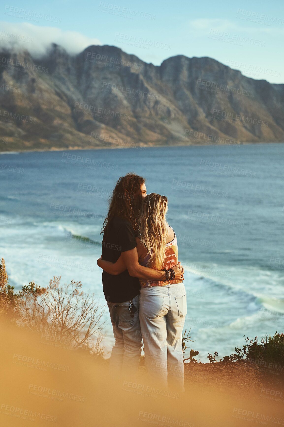 Buy stock photo Ocean, mountain and couple with hug on adventure, travel vacation and bonding together with love embrace. Outdoor, man and woman by back for anniversary, connection or holiday with affection by view