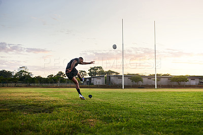 Buy stock photo Rugby, man and kick in stadium, outdoor and performance for game, match and player for competition. Professional, field and person with goals, campion and fitness of athlete, mockup and football