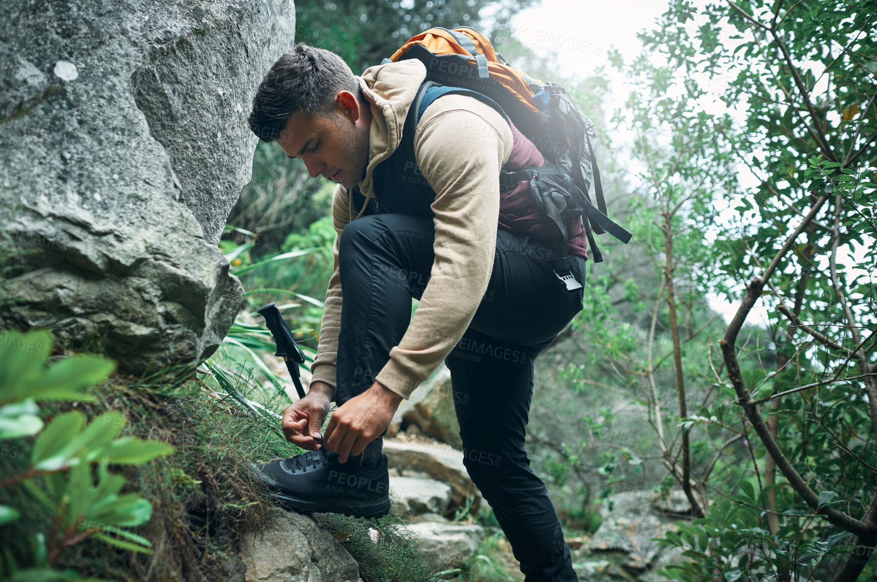 Buy stock photo Hiking, travel and tying laces with man in nature for explore, health and adventure. Challenge, wellness and holiday with person and shoes trekking on path for walking, fitness and camping vacation