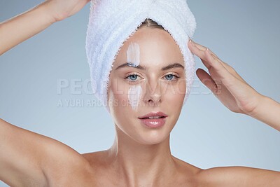 Buy stock photo Woman, skincare and portrait in studio with cream for facial, wellness or cosmetics. Towel, model girl and hygiene for beauty and lotion for dermatology, collagen or anti ageing by white background