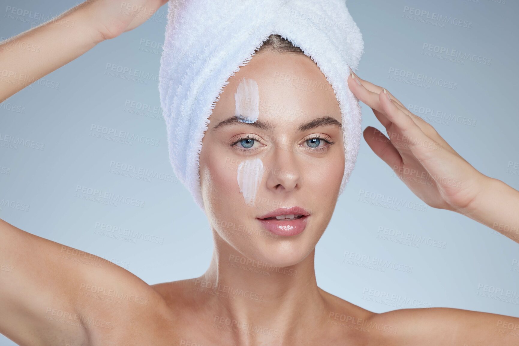 Buy stock photo Woman, skincare and portrait in studio with cream for facial, wellness or cosmetics. Towel, model girl and hygiene for beauty and lotion for dermatology, collagen or anti ageing by white background