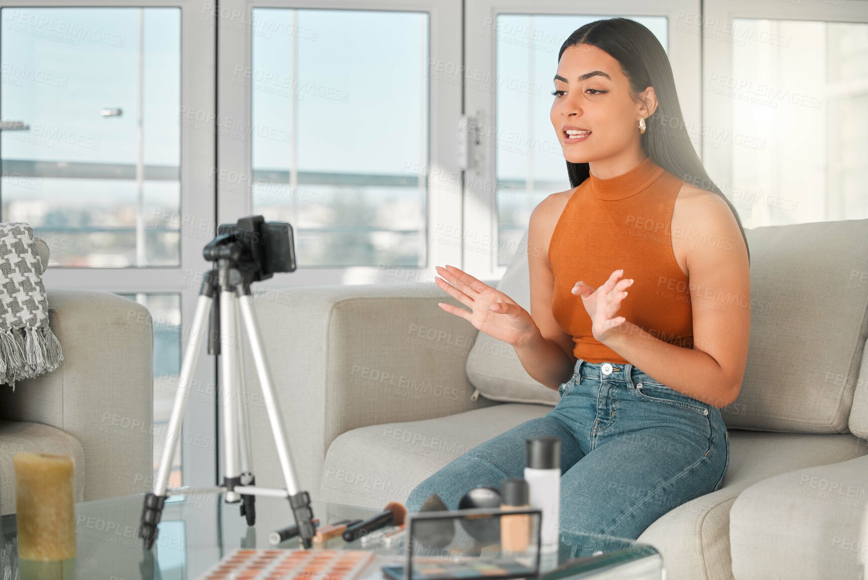 Buy stock photo Makeup, streaming and tutorial with woman influencer on sofa in living room of home for live broadcast. Cosmetics, social media and subscription service with happy content creator in apartment