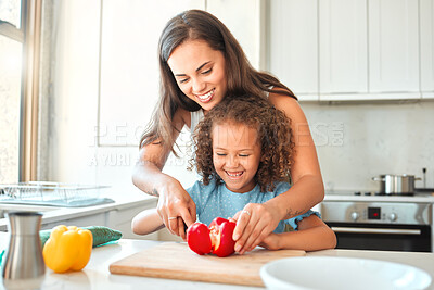 Buy stock photo Mother, girl and learning to cook with smile, help and guidance for support in kitchen. Woman, child and vegetables cut teaching for dinner, meal and healthy salad diet with fun bonding at home