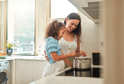 Buy stock photo Woman, girl and learning cooking with happy, smile and guidance for support in kitchen. Mother, child and teaching stove safety for dinner, meal and healthy diet preparation with fun bonding at home