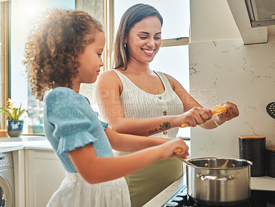 Buy stock photo Woman, girl and learning cooking with pasta, smile and guidance for support in kitchen. Mother, child and teaching stove for spaghetti dinner, meal and healthy diet preparation with bonding at home