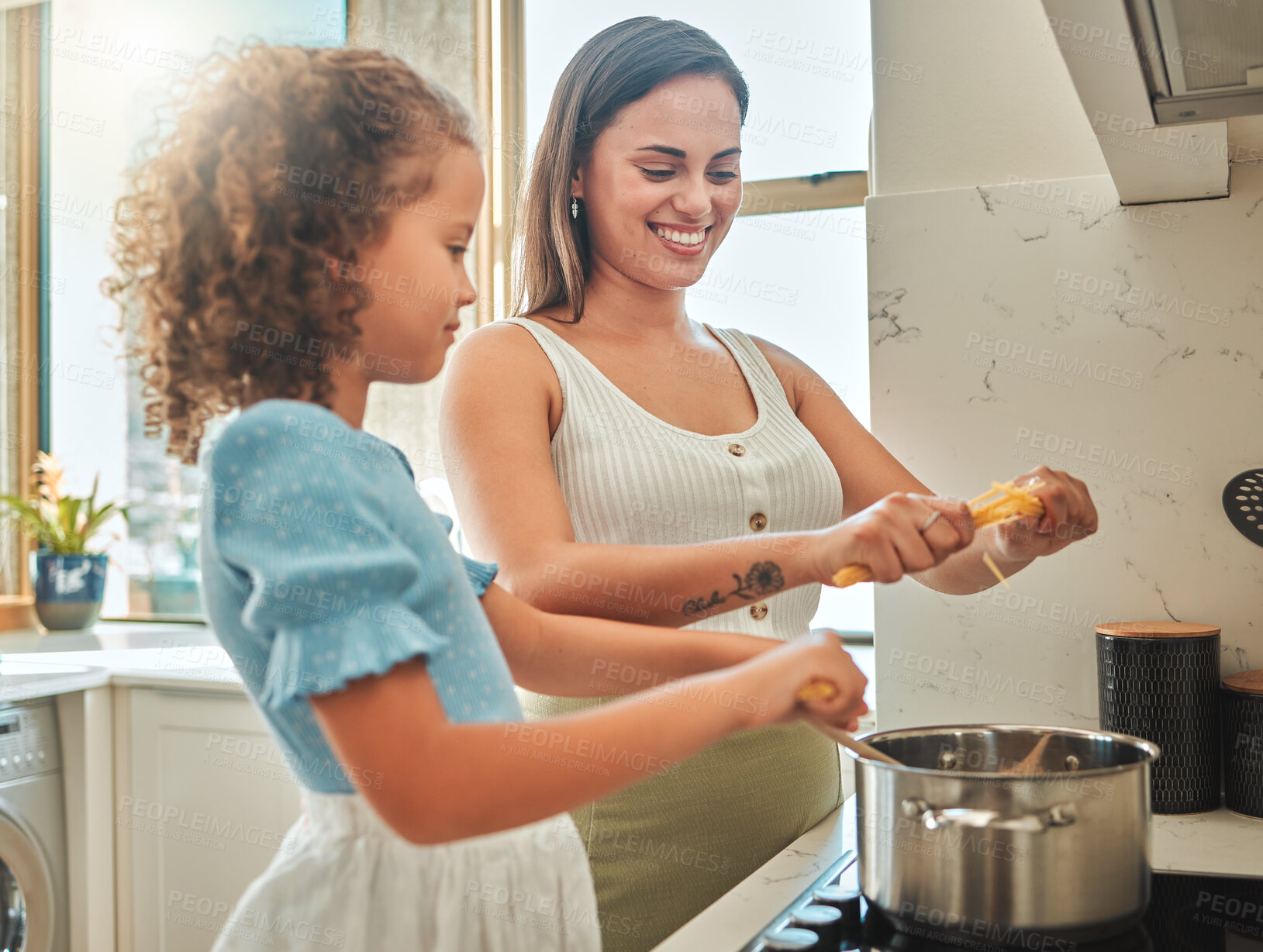 Buy stock photo Woman, girl and learning cooking with pasta, smile and guidance for support in kitchen. Mother, child and teaching stove for spaghetti dinner, meal and healthy diet preparation with bonding at home