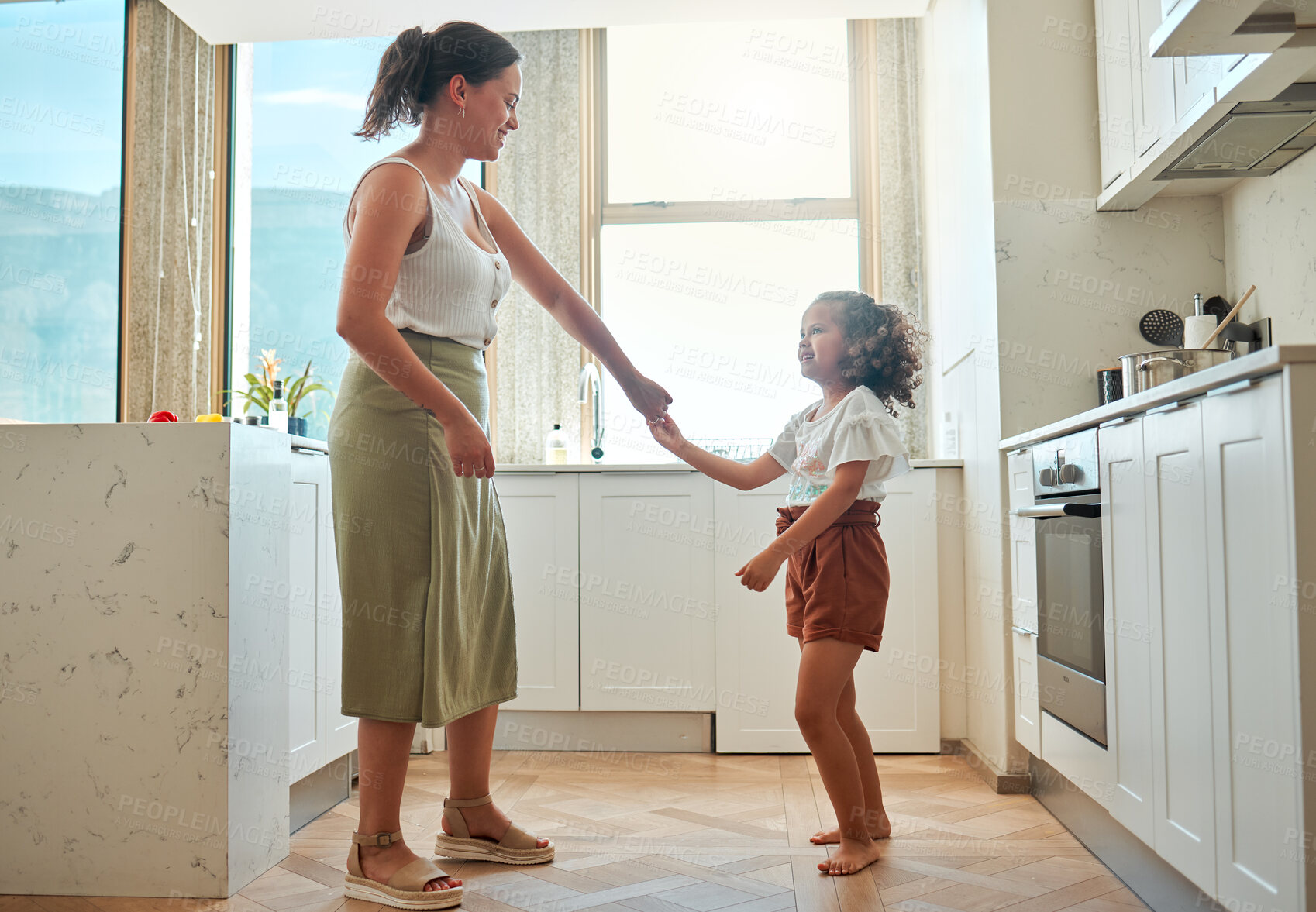 Buy stock photo Dance, smile and mother with daughter in kitchen for support, energy and music. Happiness, love and freedom with woman and child bonding in family home for fun, playful and entertainment together