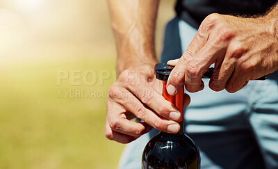 Buy stock photo Outdoor, opening and hands with wine, bottle and server for alcohol tasting, event and nature of vineyard. Environment, luxury and person with drink, sommelier and expert in farm, testing or business