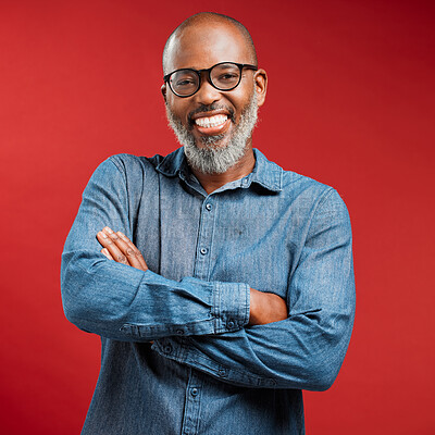 Buy stock photo Portrait, black man and glasses with confidence in studio for optometry, lens prescription and vision. Mature, person and arms crossed with medical eyewear, eyesight and treatment on red background