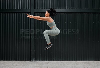 Buy stock photo Athlete, woman and jumping for exercise outdoor with fitness, sports training and energy of health workout. Active, girl and leap with cardio performance, endurance progress and competition practice