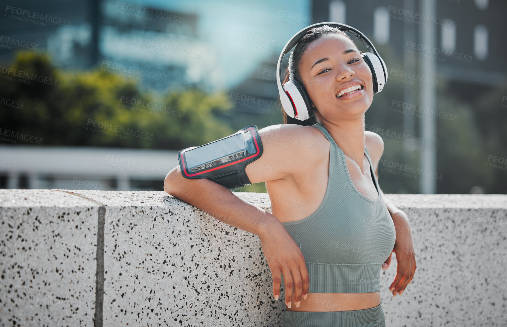 Buy stock photo Fitness, girl and headphones with portrait in city for exercise break, listening to music and relax with phone strap. Athlete, runner and happy woman in urban town for morning jog and cardio training