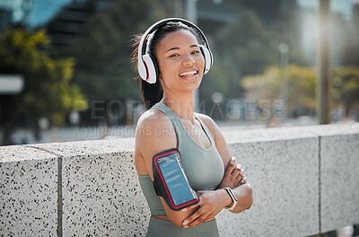 Buy stock photo Fitness, woman and headphones with arms crossed portrait in city for exercise break, listening to music and relax with phone strap. Athlete, runner and girl in urban town for morning jog and cardio