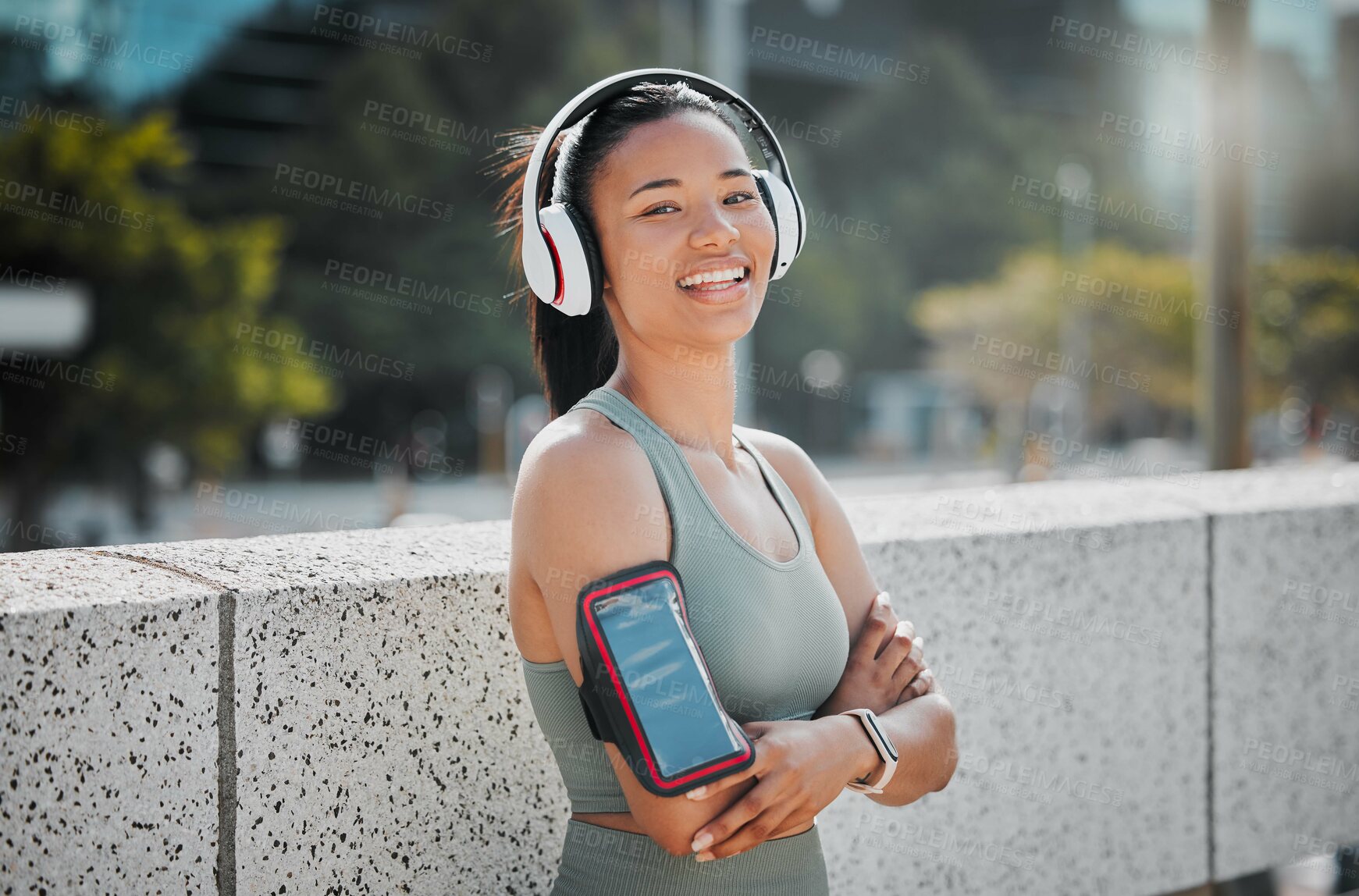 Buy stock photo Fitness, woman and headphones with arms crossed portrait in city for exercise break, listening to music and relax with phone strap. Athlete, runner and girl in urban town for morning jog and cardio