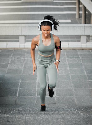 Buy stock photo Active, girl and running with headphones outdoor for cardio training, listen to music and marathon practice. Athlete, woman and fitness exercise with endurance, sports workout and race performance