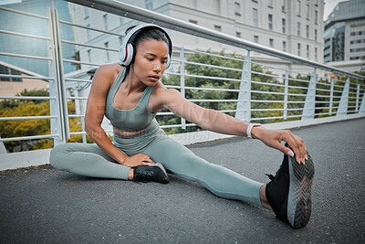 Buy stock photo Ground, woman or runner stretching in city for fitness, training and exercise health on bridge. Legs, music headphones and girl athlete in warm up for workout performance, jog or sports challenge