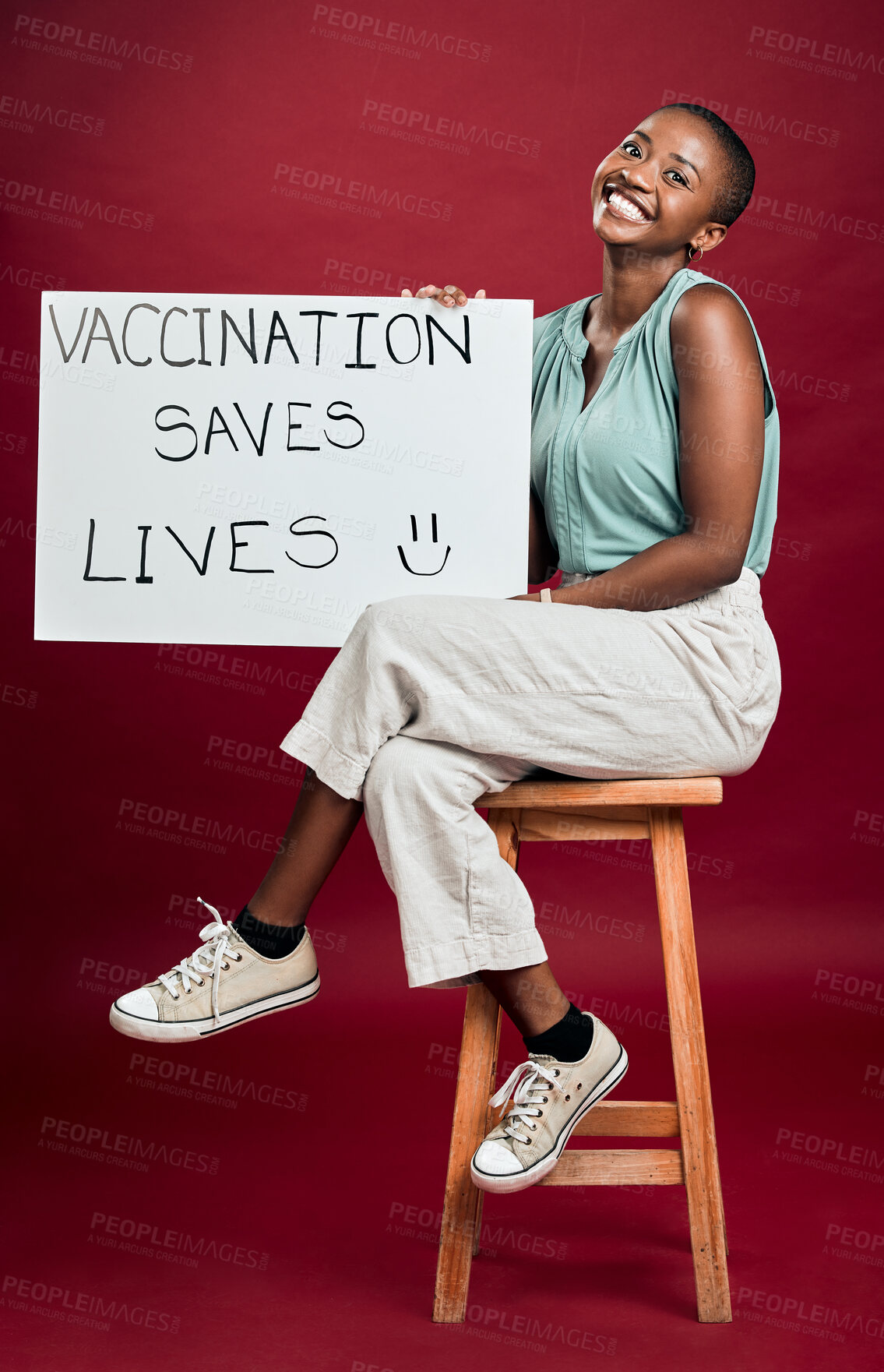 Buy stock photo Happy, poster and vaccine with portrait of black woman in studio on red background for healthcare or medical. Covid, smile and vaccination saves lives sign with person for support or wellness