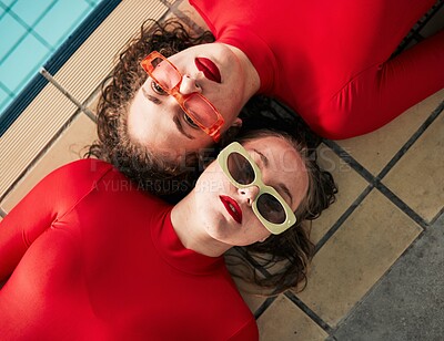 Buy stock photo Women, sunglasses and urban fashion at a pool with gen z, hipster and style of girl friends with top view. Red clothing, cool and trendy glasses with young people on a floor with student model