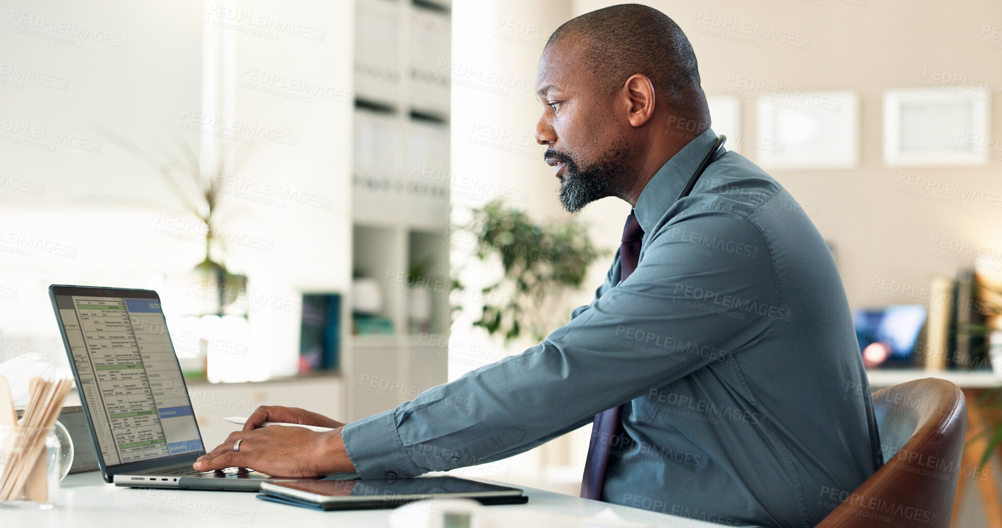 Buy stock photo Typing, doctor and man with laptop, reading and serious for health records, wellness and office in hospital. Healthcare, working and black person with app for info, professional or analysis in clinic