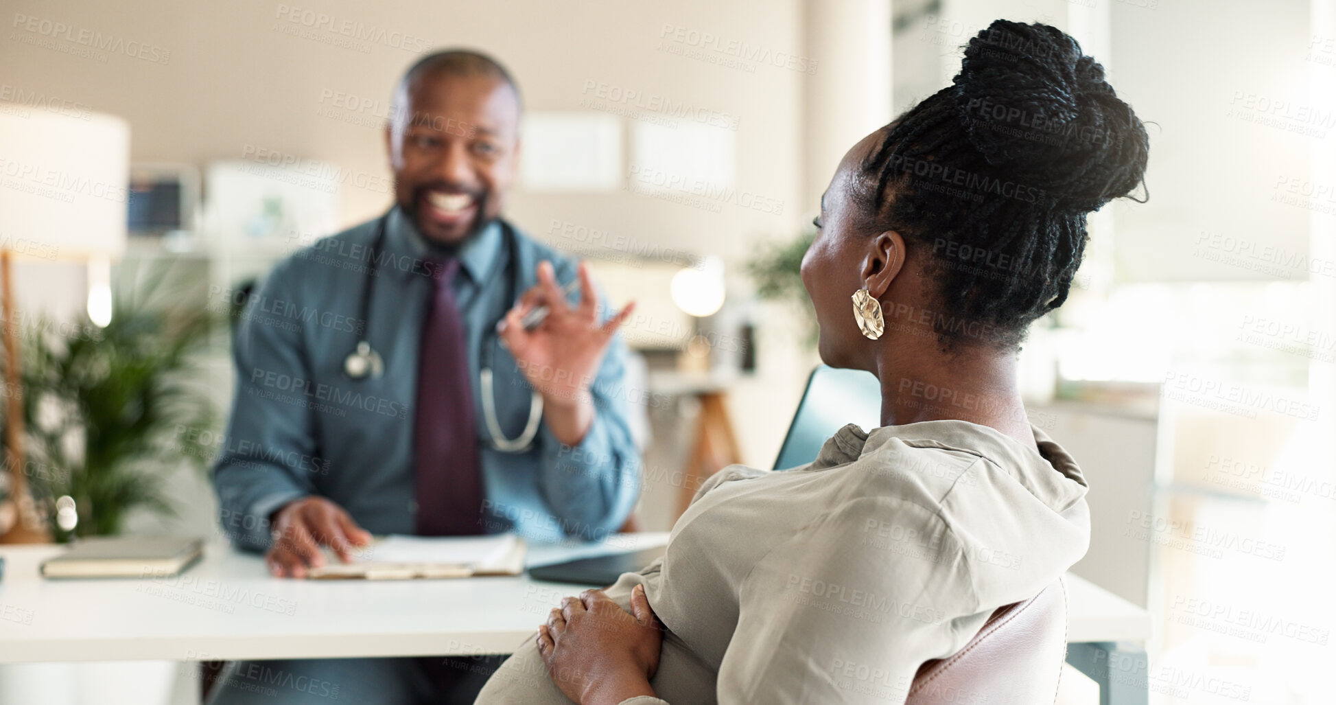 Buy stock photo Healthcare, okay or pregnancy with doctor and patient in office at hospital for consulting or positive feedback. Gesture, smile and medical professional man talking to pregnant woman in clinic