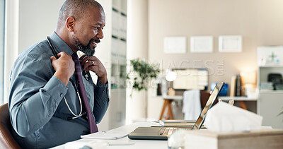 Buy stock photo Healthcare, laptop and stethoscope with doctor black man in office of hospital for medical research. Computer, review and smile of mature medicine professional at desk in clinic for cardiology