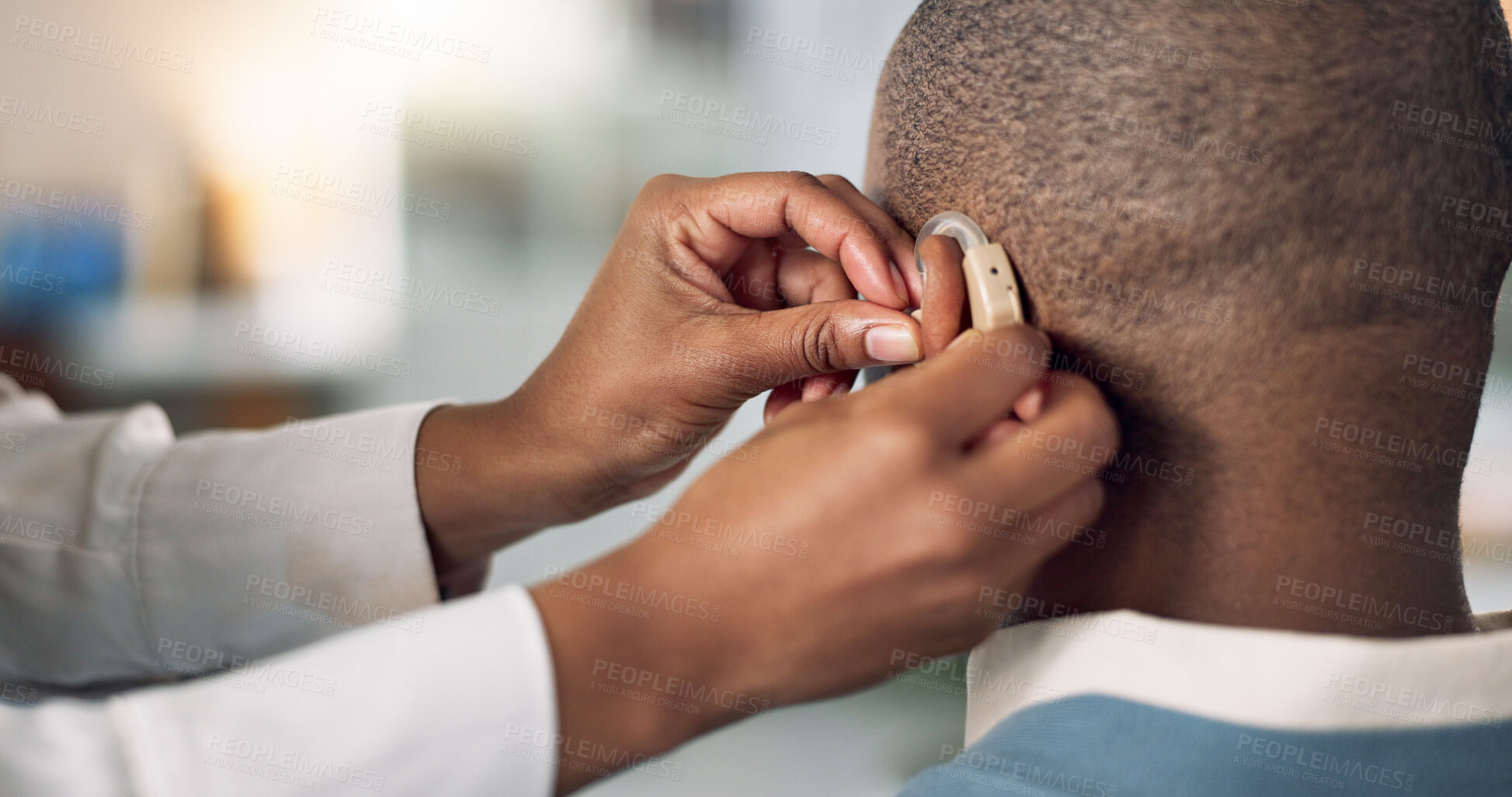 Buy stock photo Man, ear and hearing aid fitting with hands, medical support and care with implant for sound and audio. Deaf, back and check of patient with a disability in hospital for technology and installation