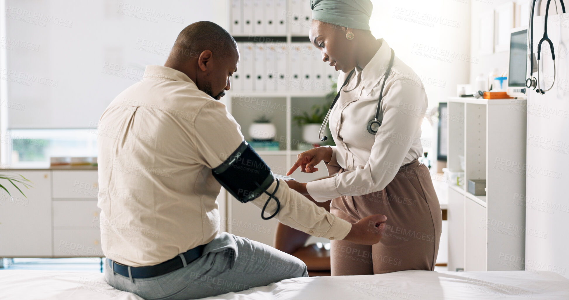 Buy stock photo Woman, doctor and patient with blood pressure machine for checkup, exam or test on bed at hospital. Female person, medical employee or healthcare worker with client for artery or heart pump at clinic