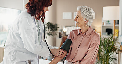 Buy stock photo Blood pressure, patient and doctor with consultation, smile and checkup in hospital. Pensioner, elderly woman and medical with professional, appointment or healthcare with communication or cardiology