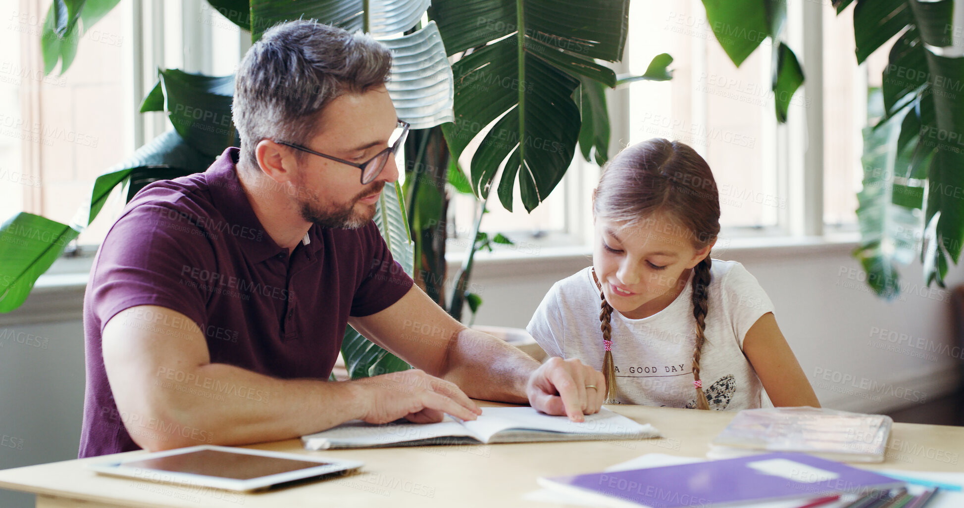 Buy stock photo Reading, dad and child with homework, home and studying for project, helping and education for daughter. House, learning and man with kid, knowledge and girl with assignment, growth and development