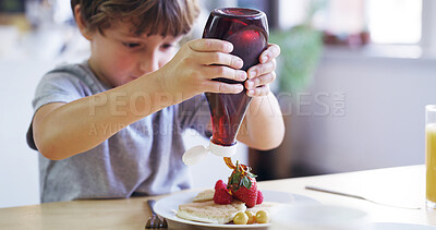 Buy stock photo Child, kitchen and pancakes for breakfast with fruit as food, nutrition and diet in home for morning. Young boy, hungry and syrup for brunch, cooking and delicious meal with preparing or ingredients