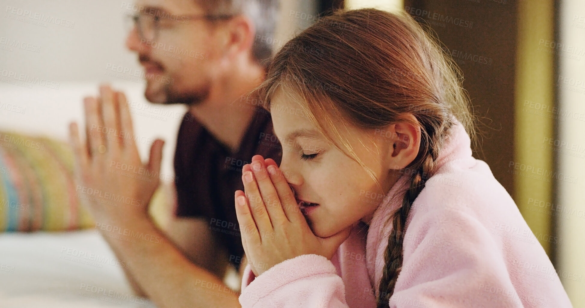 Buy stock photo Child, man and religion with praying on bed together in home for bedtime faith or worship. Belief, gratitude or trust with daughter and single parent dad in prayer to God or Jesus at apartment