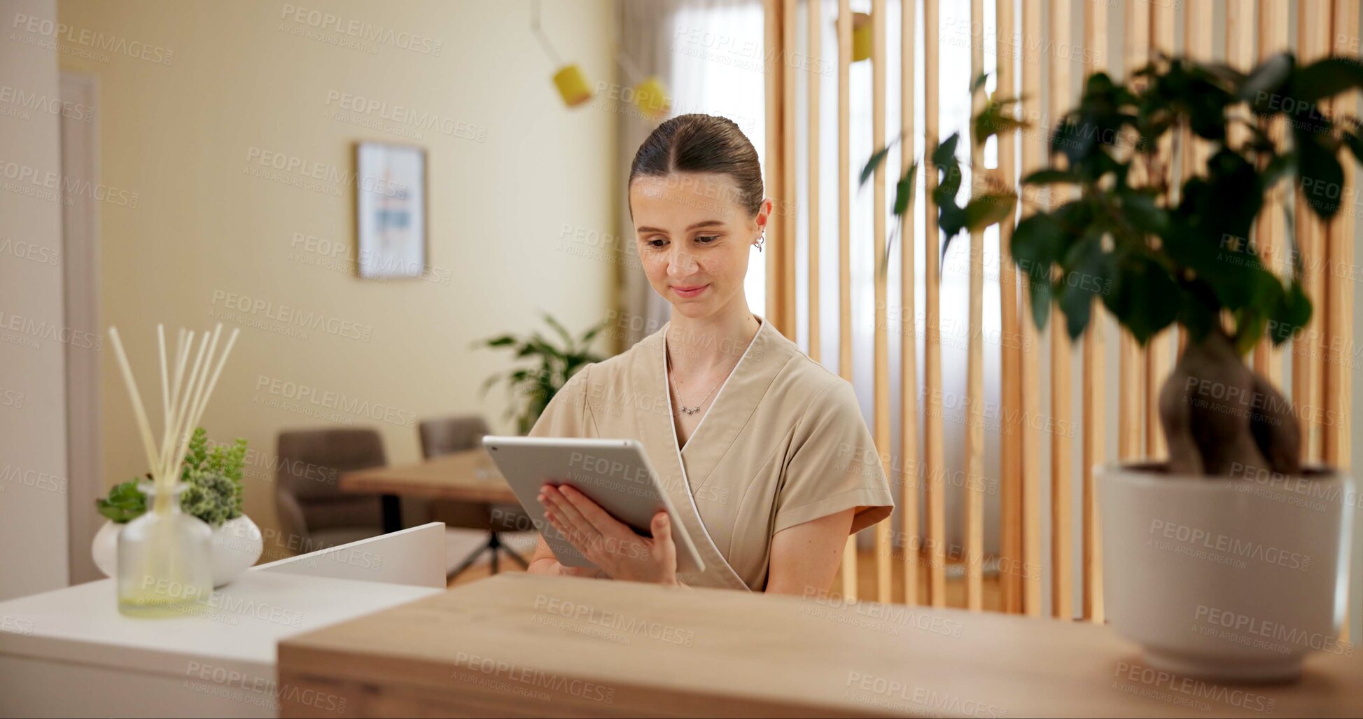 Buy stock photo Beauty, spa and woman at front desk with tablet checking website for online appointment booking. Consultant, receptionist or girl at reception with digital app for schedule plan at luxury hotel salon