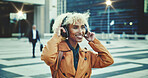 Happy woman, listening and music with headphones in city for sound, radio or audio streaming. Young, female person or citizen with smile or headset for tune, playlist or song album in an urban town
