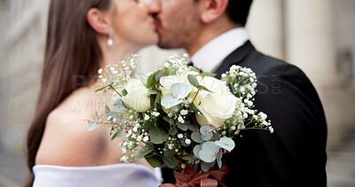Buy stock photo City, flowers and couple at wedding with kiss, love and bride with groom in street together in commitment. Urban romance, man and woman with court marriage, bouquet and happy outdoor celebration.
