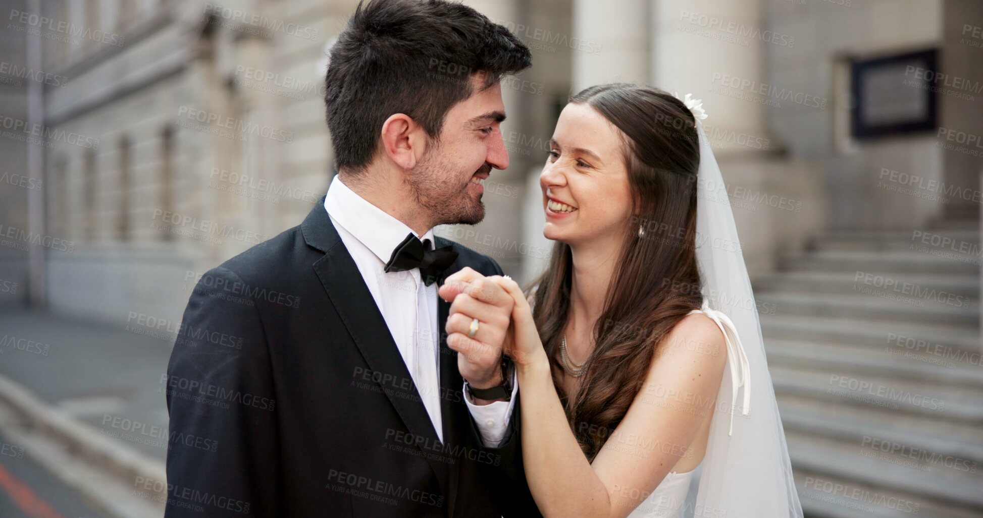 Buy stock photo Happy, couple and holding hands on wedding with promise, celebration and marriage commitment. Smile, people and love with affection for partnership, relationship loyalty and romance ceremony at court