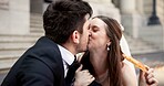 Couple, kiss and pizza on wedding outdoor for celebration, unity success and marriage commitment. Smile, people and food with promise for partnership, love relationship and romance ceremony at court